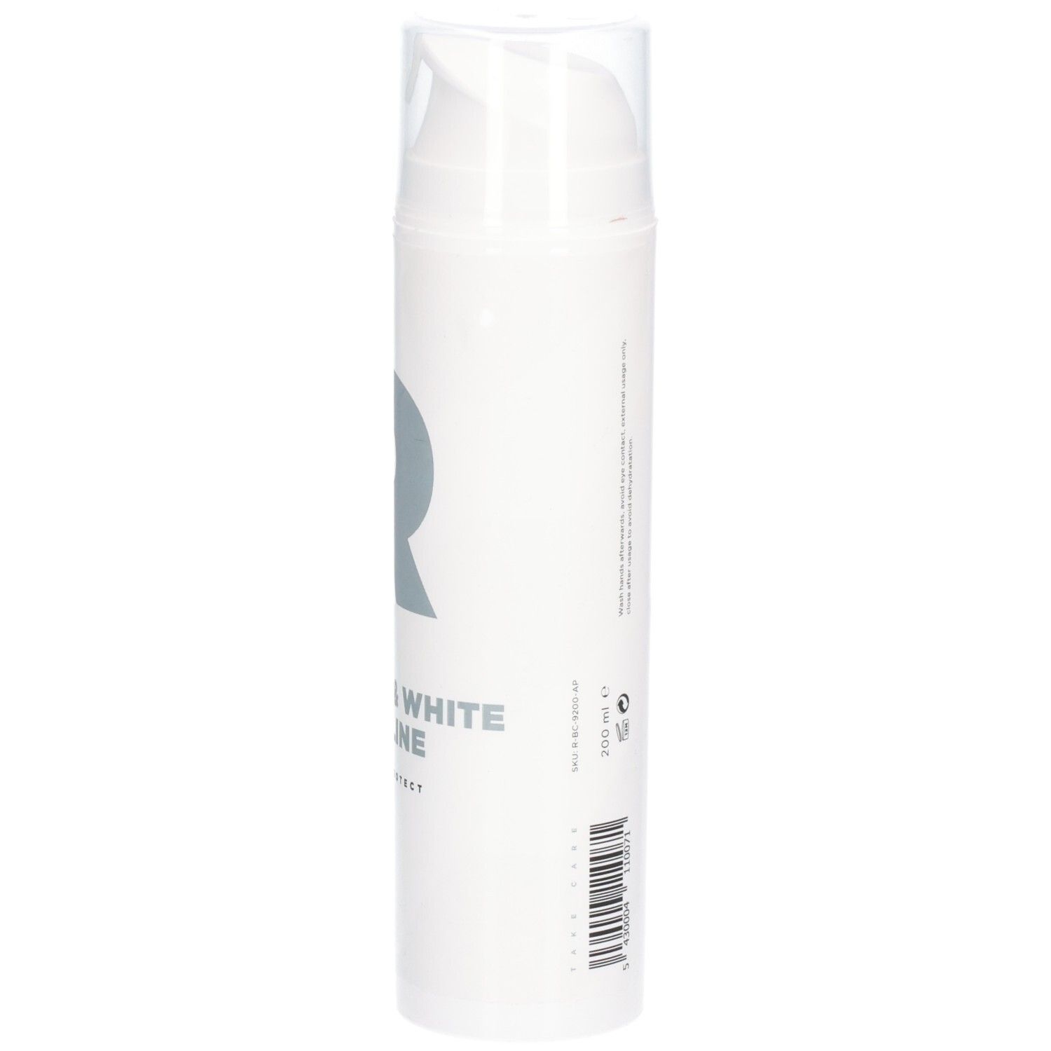 Witte fles met pomp. Opschrift: RÉVVI Pure & White Vaseline. Grijs logo.