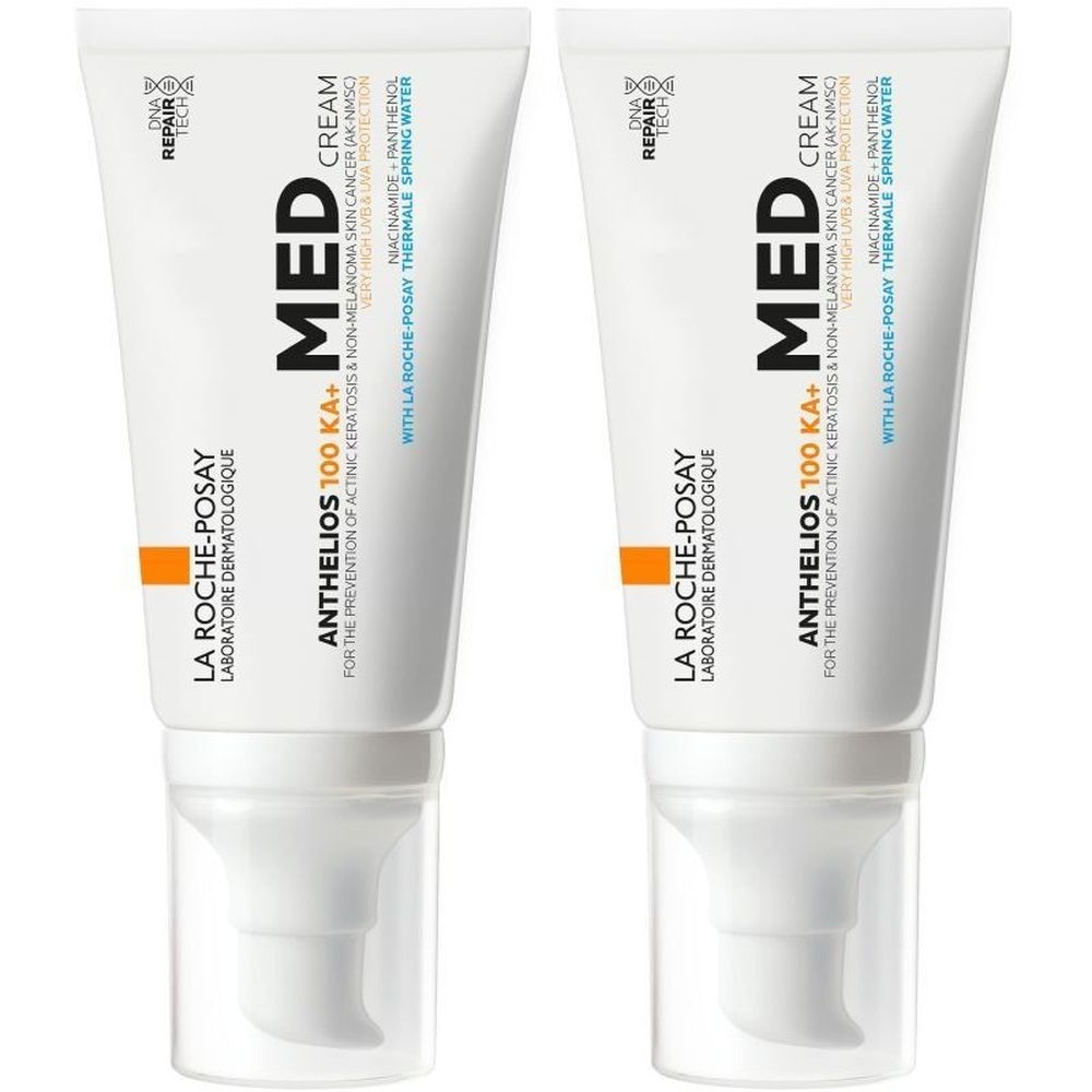Twee tubes La Roche-Posay Anthelios 100 KA+ Med Crème. Witte tubes met blauwe en oranje tekst. Met doseerkop.