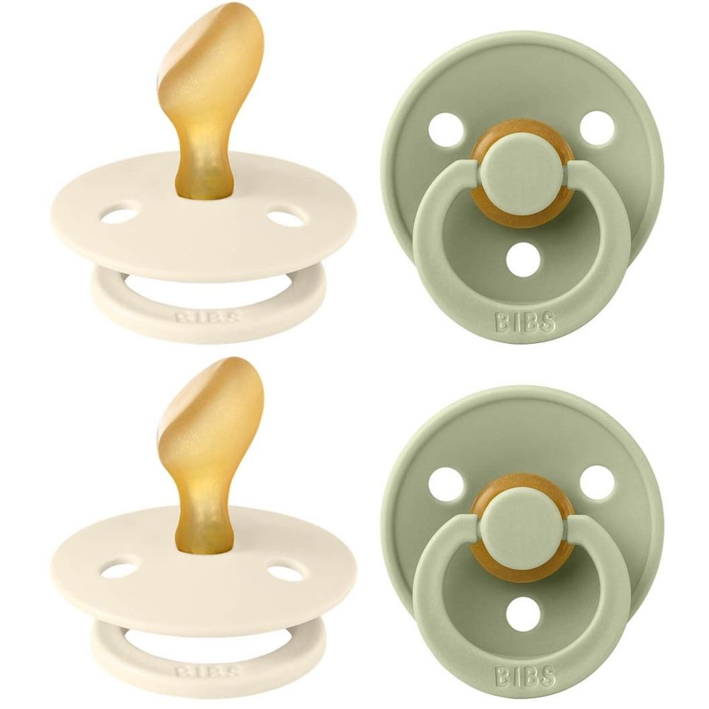 Deux sucettes, ivoire et sauge. Forme ronde avec anneau et tétine. Logo BIBS visible.