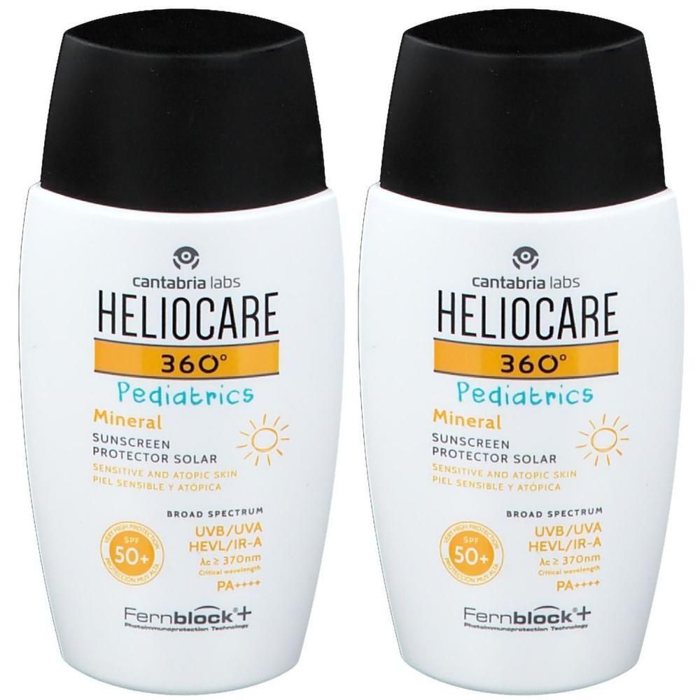 Deux flacons de crème solaire Heliocare 360° Pediatrics Mineral SPF50+. Flacons blancs, bouchons noirs, étiquette jaune.