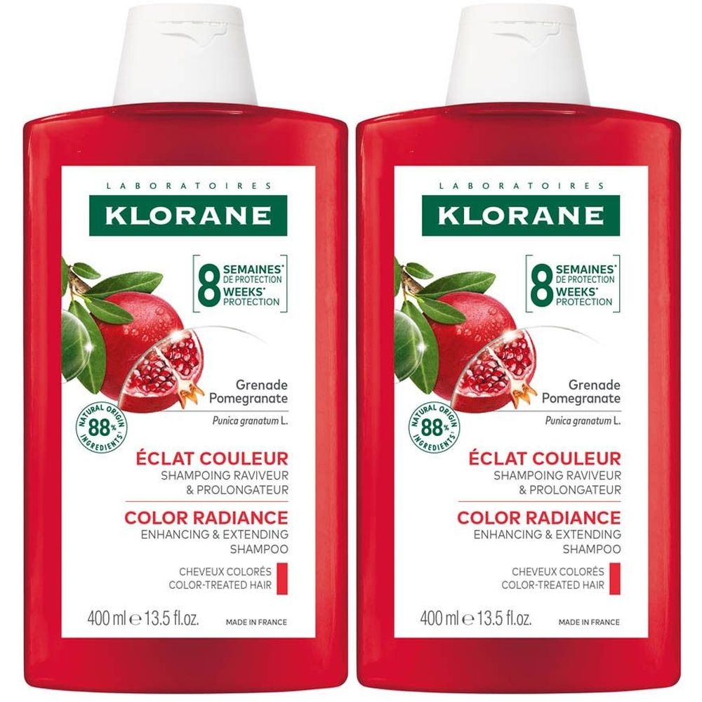 Twee rode shampoo flessen. Opschrift: Klorane, Granaatappel, Éclat Couleur, Color Radiance, voor gekleurd haar. 400 ml.