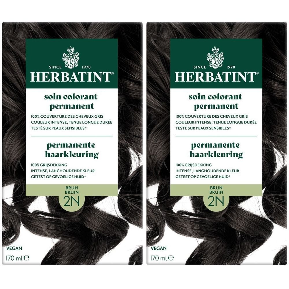 Deux boîtes de Herbatint Soin Colorant Permanent 2N Brun. Emballage noir avec informations produit et logo. Vegan.