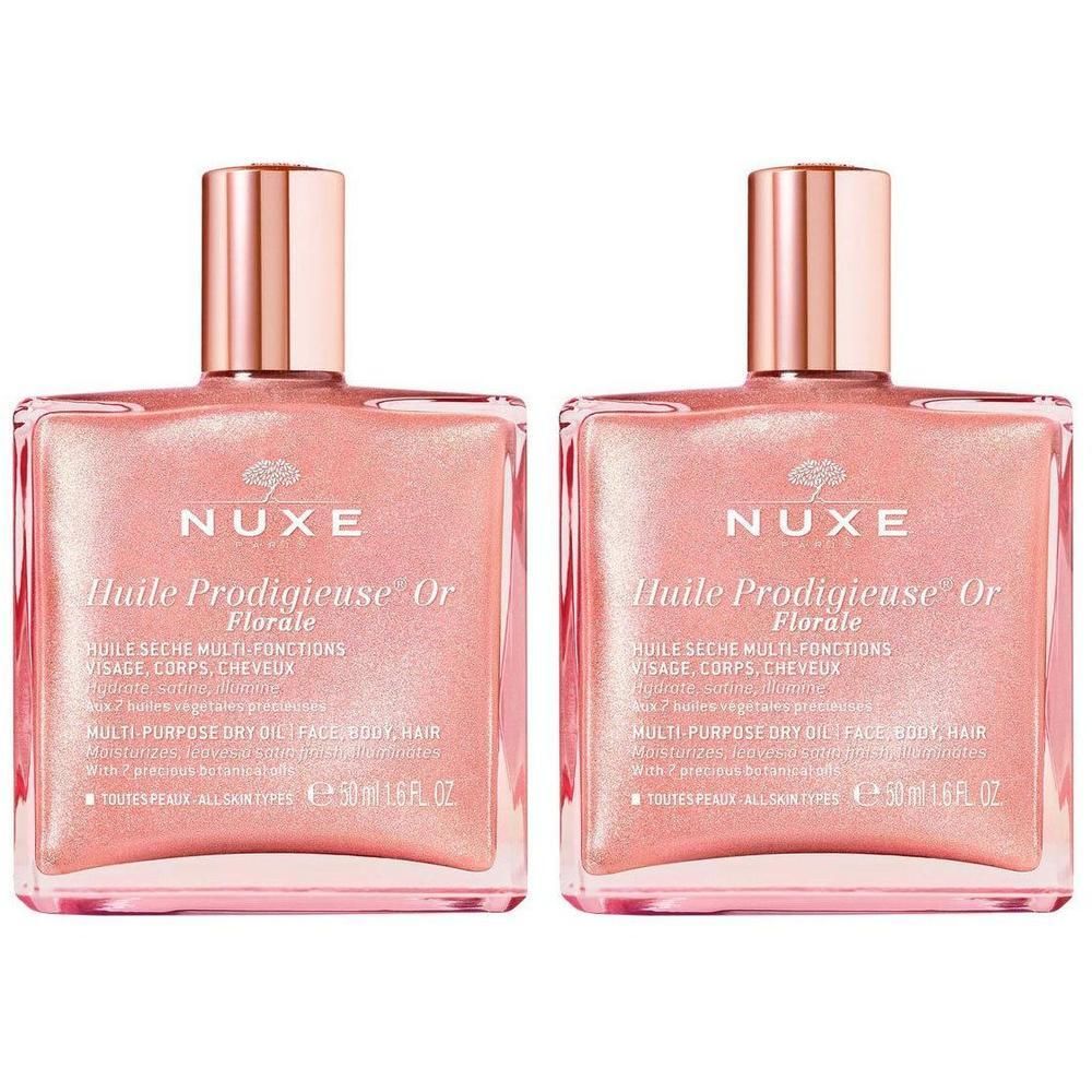 Twee vierkante flacons met roze olie en gouden dop. Opschrift: Nuxe Huile Prodigieuse Or Florale.
