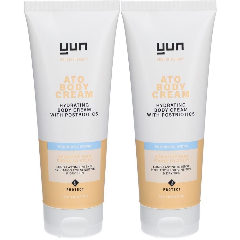 Twee tubes YUN ATO Body Cream. Witte tubes met tekst en productinformatie. Beige en lichtblauwe accenten.