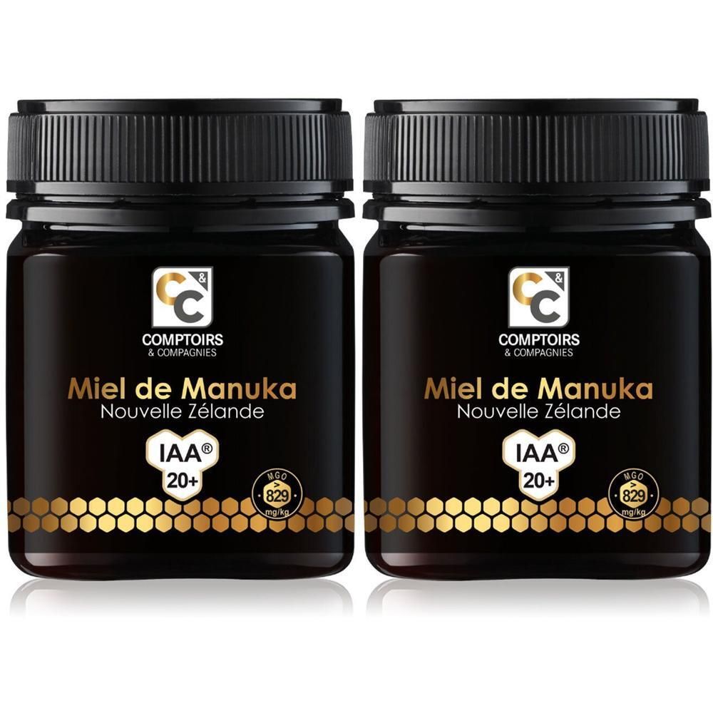 Deux pots de Miel de Manuka IAA 20+ de Comptoirs & Compagnies. Pots noirs avec étiquettes dorées et couvercles.