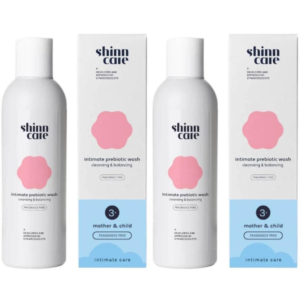 Plusieurs flacons et emballages. Blanc, logo rose et texte. "Intimate prebiotic wash".