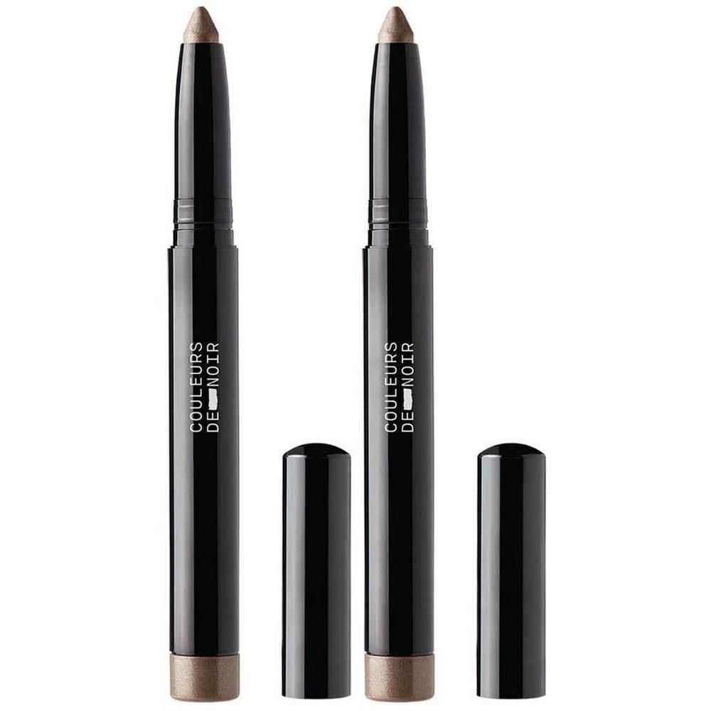 Twee Couleurs de Noir oogschaduwsticks, zwart, met open doppen. De sticks zijn bruin-goud.