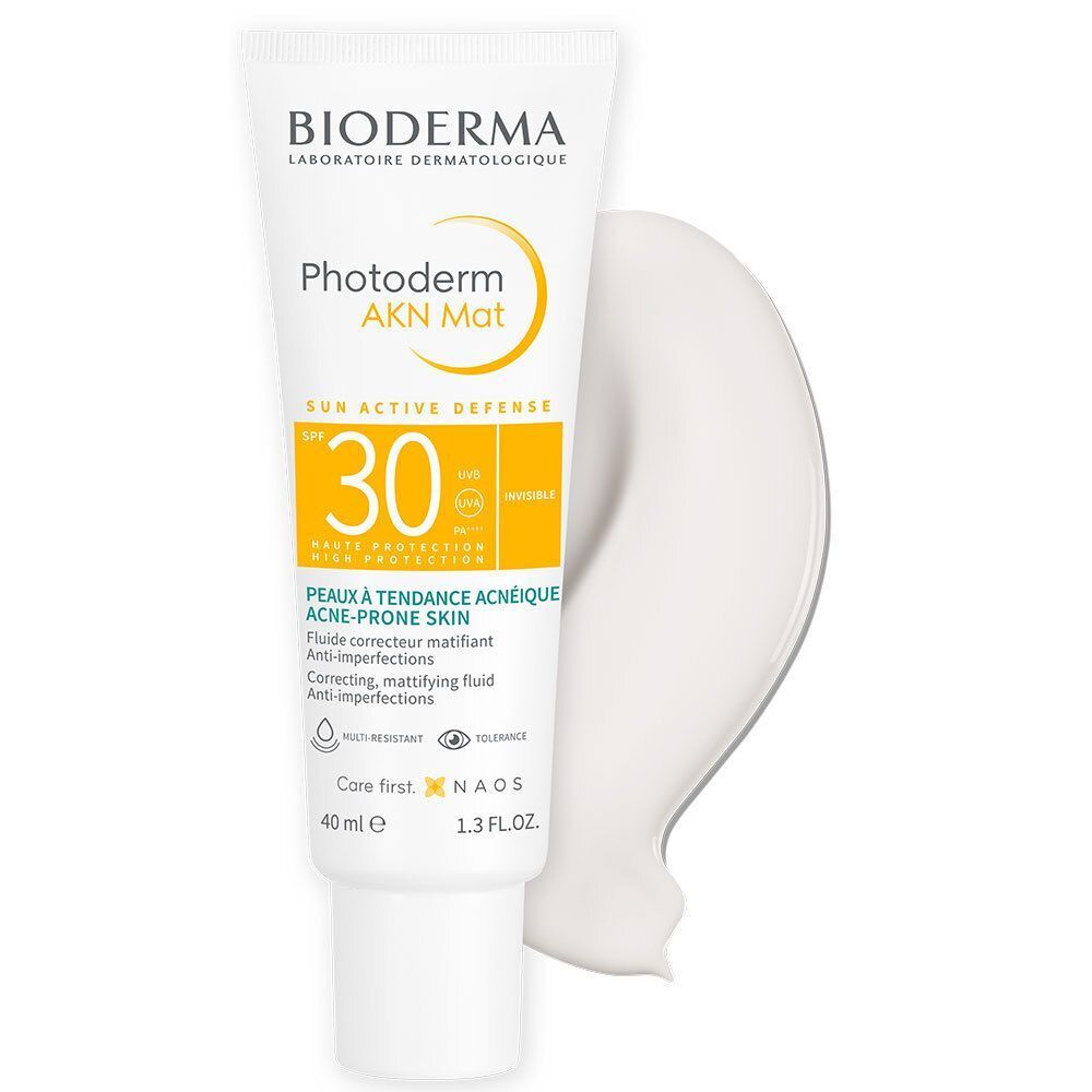 Tube BIODERMA Photoderm AKN Mat SPF30 en productmonster. Witte tube met gele accenten en een spoor van het product.