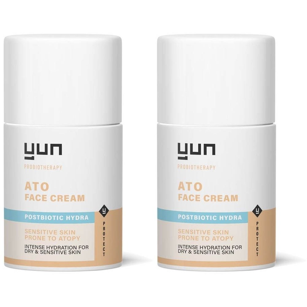 Twee witte crèmeflacons met de tekst "YUN ATO FACE CREAM". Tekst: "Postbiotic Hydra", "Sensitive Skin prone to Atopy". 