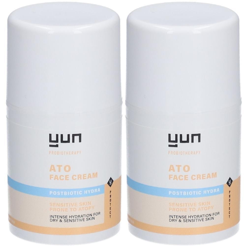 Twee witte crèmetubes met blauwe en beige etiketten. Opschrift: ATO FACE CREAM, Postbiotic Hydra. Voor droge en gevoelige huid.