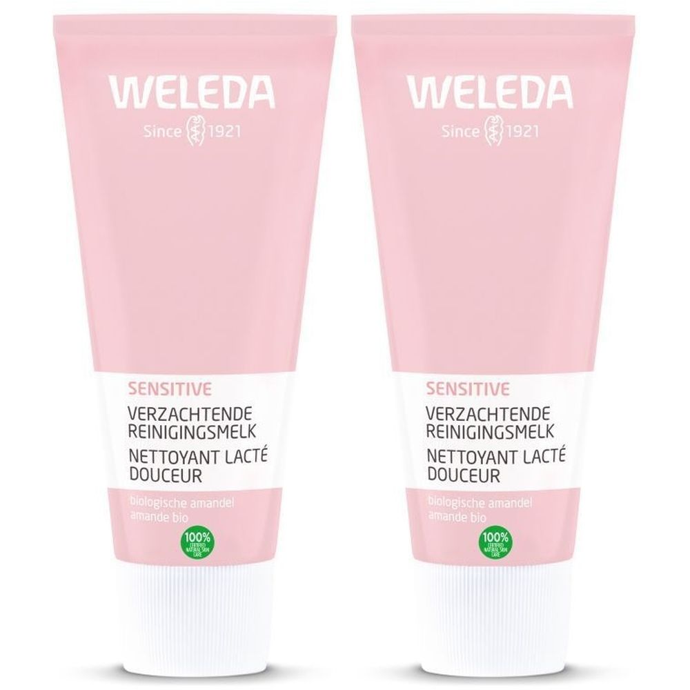 Deux tubes de lotion rose. Inscription : WELEDA, Sensitive, Nettoyant Lacté Douceur. Label bio.