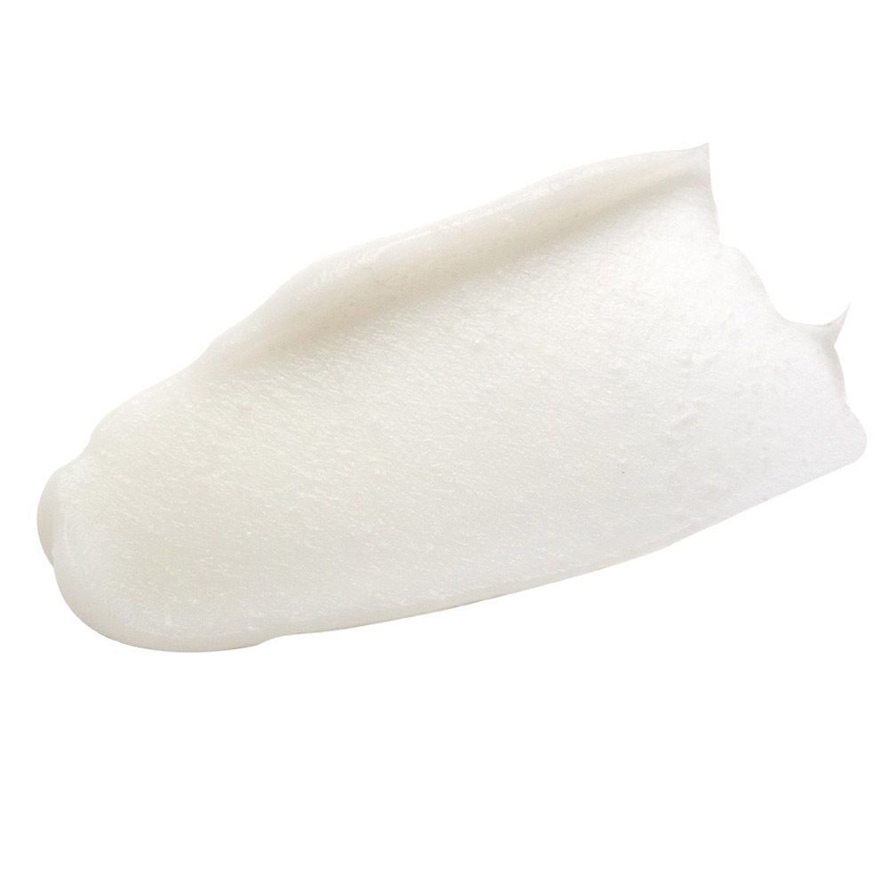 Une touche de produit blanc étalée sur une surface.