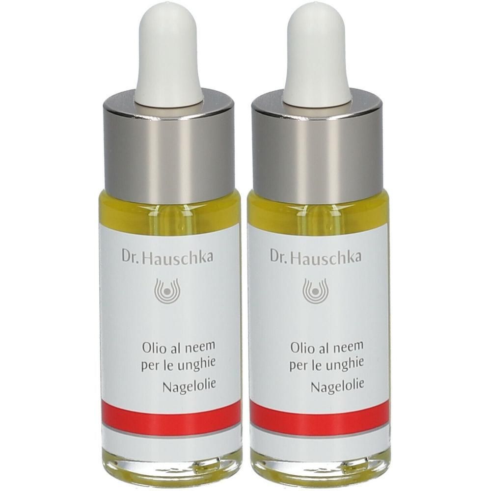 Twee flesjes met gele vloeistof. Opschrift: Dr. Hauschka, Olio al neem per le unghie, Nagelolie. Met pipet.