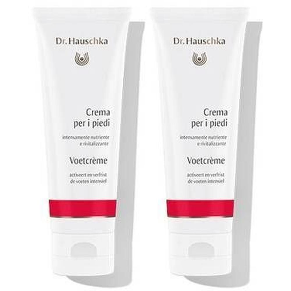 Deux tubes de crème pour les pieds. Blancs, avec bande rouge et texte. Marque : Dr. Hauschka. Inscription : Crema per i piedi, Voetcrème.