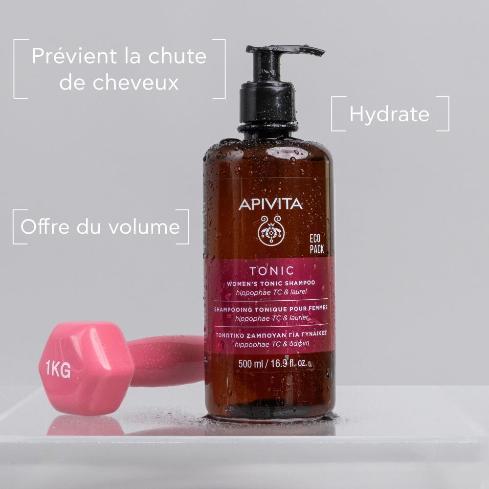 Flacon de shampooing Apivita Tonic pour femmes. Flacon brun avec pompe. Haltère rose à côté.