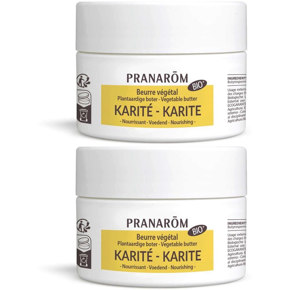 Twee witte potten met gele etiketten. Opschrift: Pranarôm Beurre végétal Karité-Karité. BIO-label.