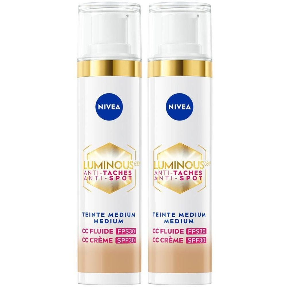 Twee flacons Nivea Cellular Luminous 630 CC Fluid Cream SPF30 Medium. Wit, met gouden en blauwe accenten. Tekst: Anti-Taches, SPF30.