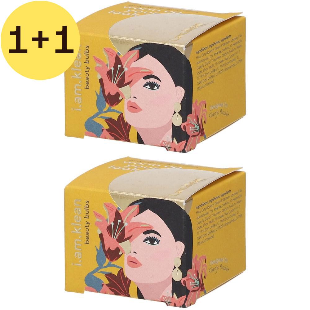 Deux boîtes jaunes avec impression. Impression : visage de femme, fleurs, texte i.am.klean beauty bulbs.