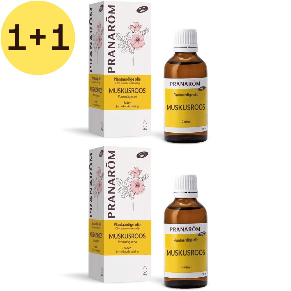 Meerdere flessen en verpakkingen van Pranarôm Huile Végétale Rose Musquée. Amberkleurige glazen fles, witte dop, gele label.