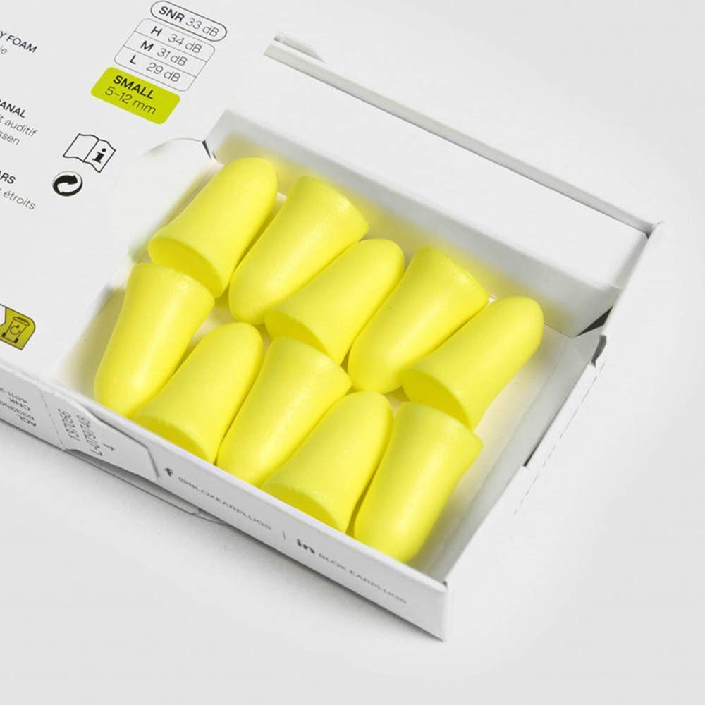 Open doos met gele oordopjes. De oordopjes zijn cilindrisch. De doos is wit.