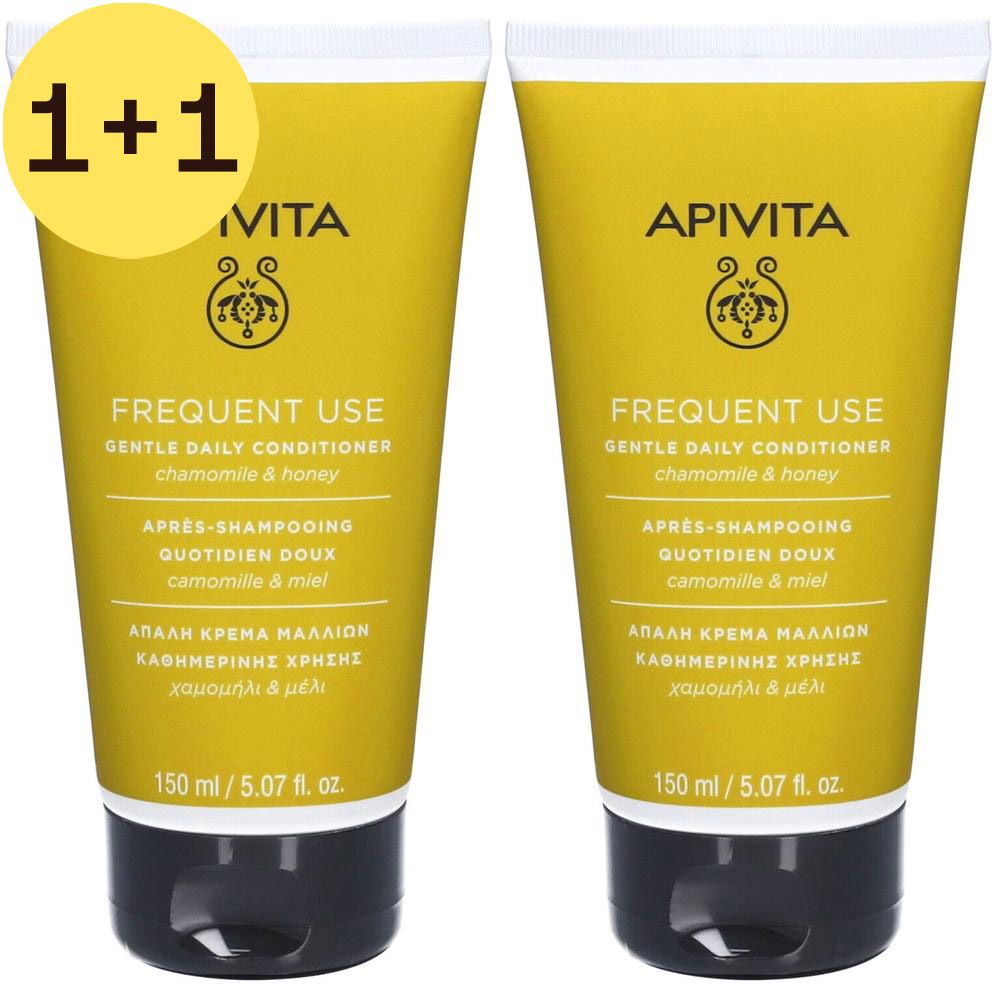 Deux tubes de revitalisant Apivita. Tubes jaunes avec bouchon noir. Inscription: Frequent Use, Camomille & Miel, 150 ml.