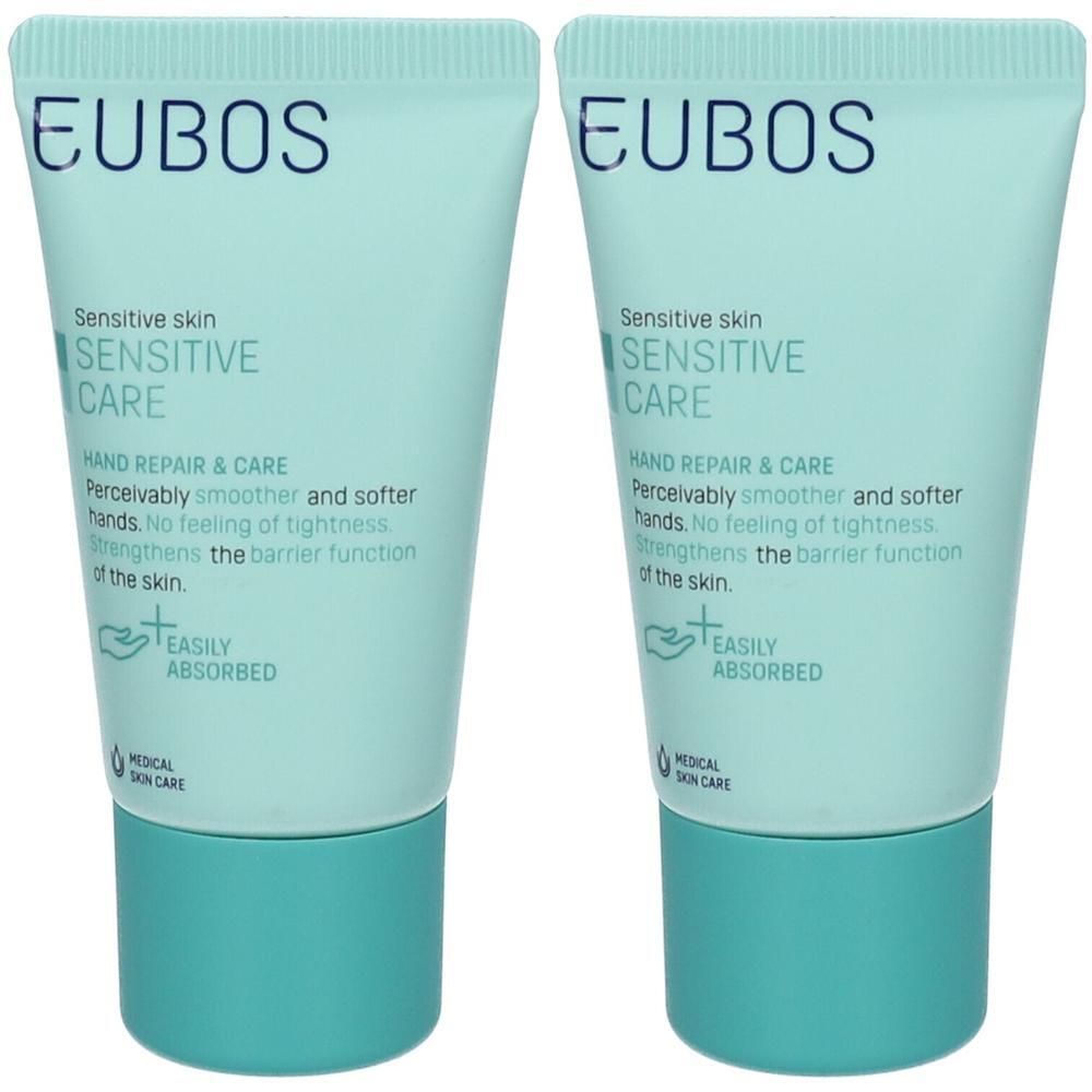 Twee tubes EUBOS Sensitive Hand Repair & Care. Lichtblauwe tubes met turkooiskleurige doppen. Tekst: Sensitive Skin, Hand Repair & Care.