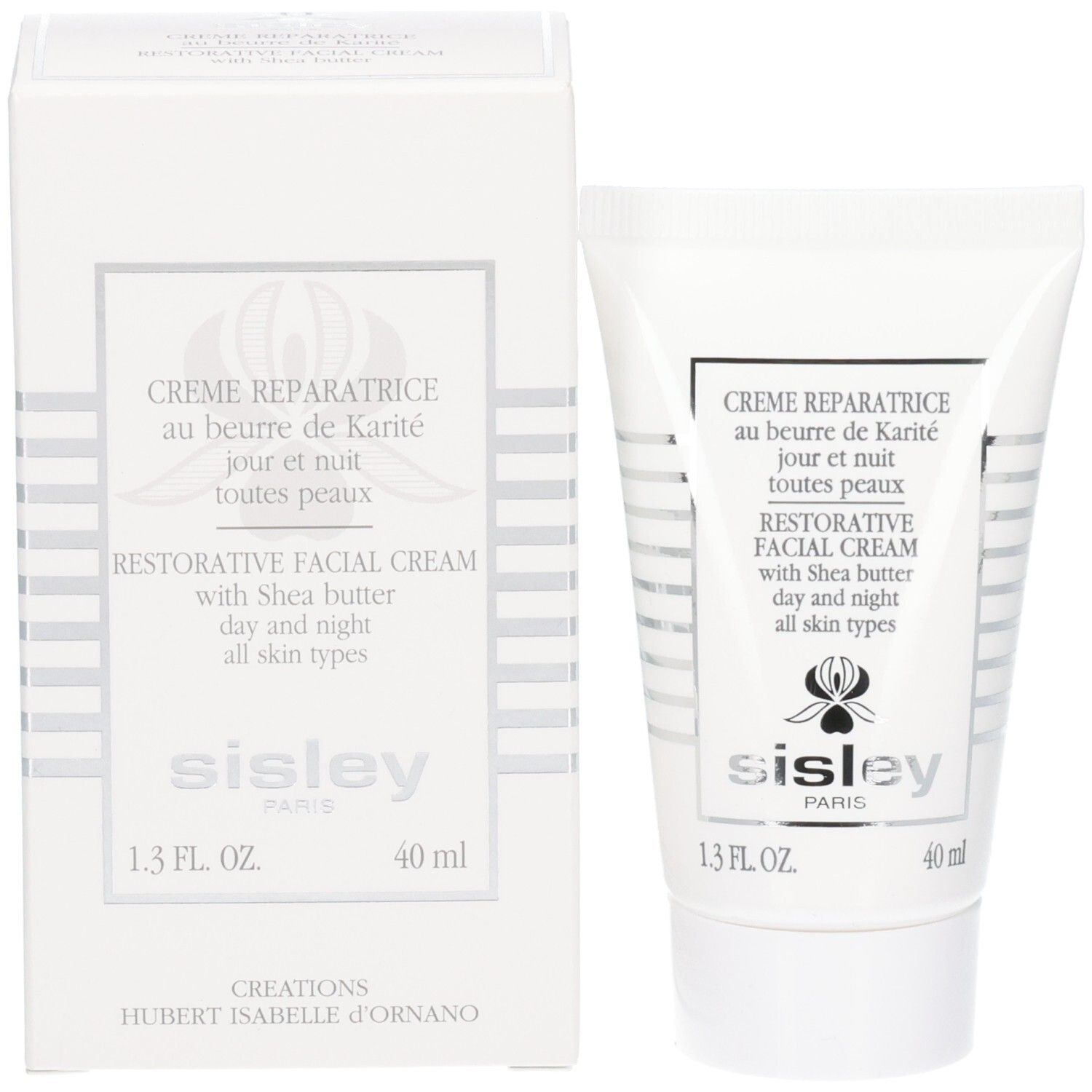 Sisley Creme Reparatrice crème pour le visage à côté de sa boîte. Blanc avec accents argentés.