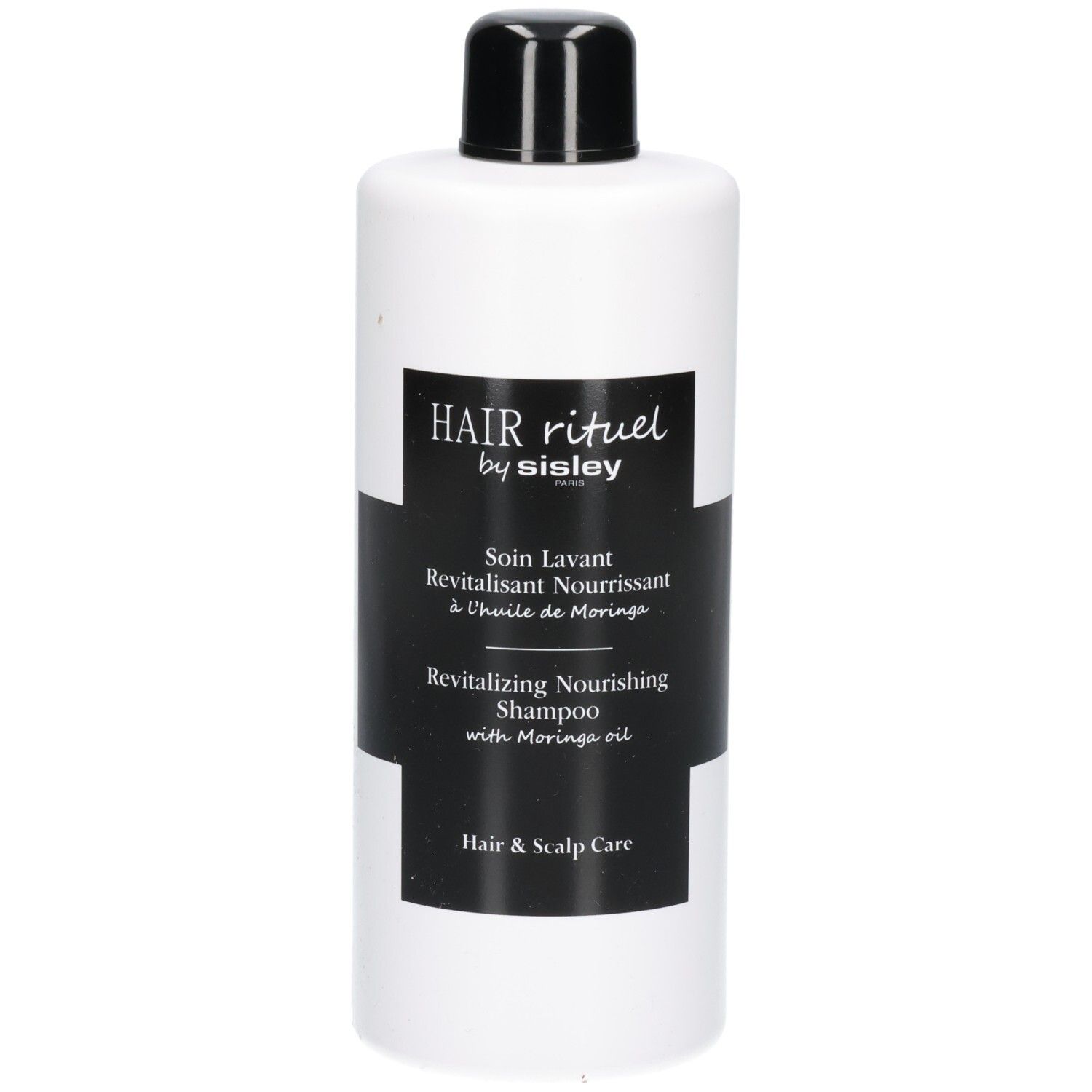 Witte fles met zwart etiket: Revitalizing Nourishing Shampoo.