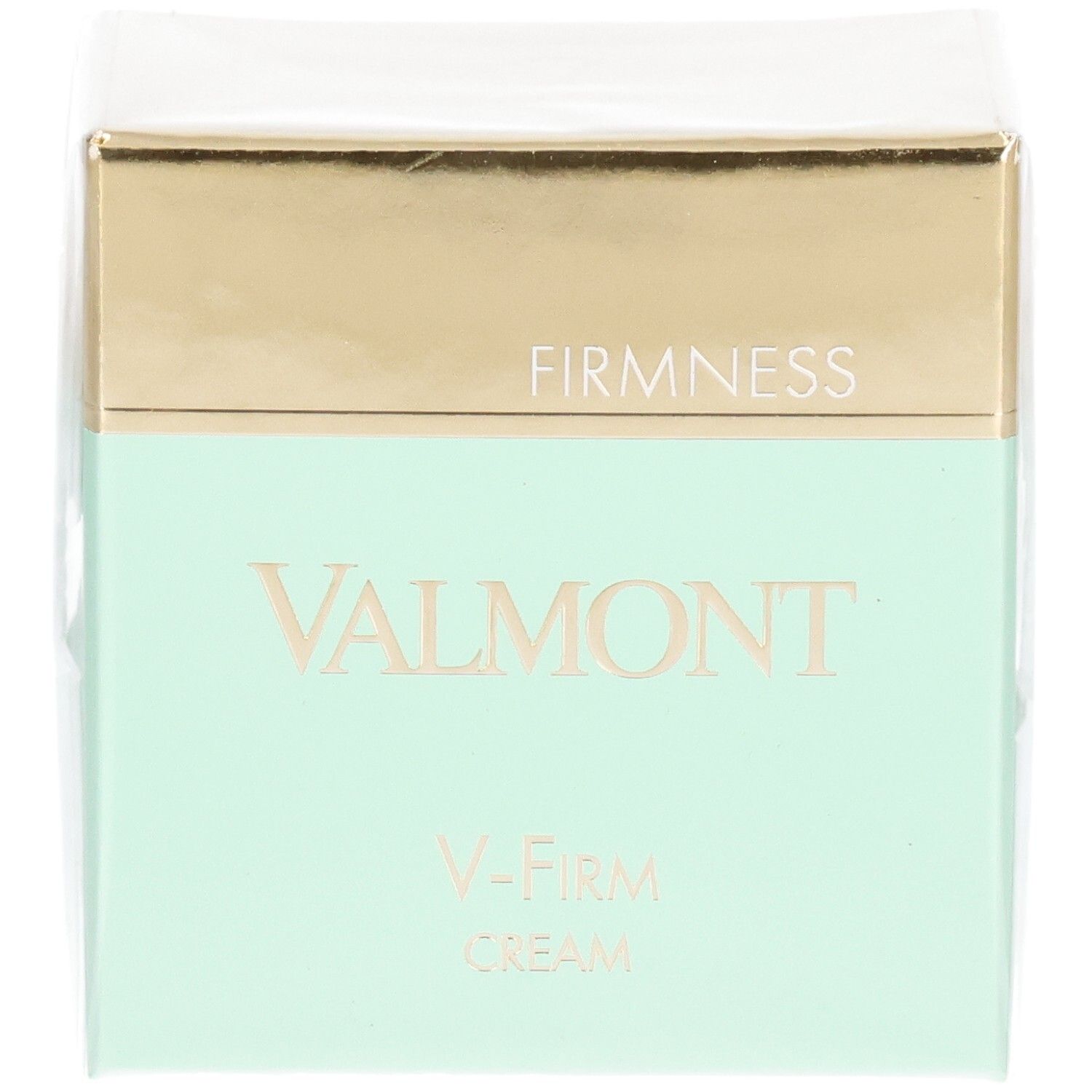 Valmont V-Firm Cream verpakking met gouden en mintgroene band. "FIRM NESS" en "VALMONT" zijn op de voorkant gedrukt.