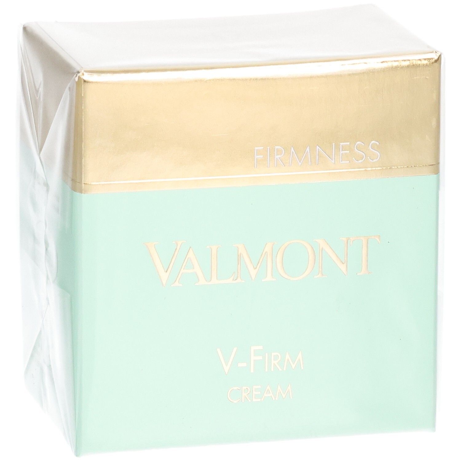 Valmont V-Firm Cream verpakking met gouden en mintgroene band. "FIRM NESS" en "VALMONT" zijn op de voorkant gedrukt.