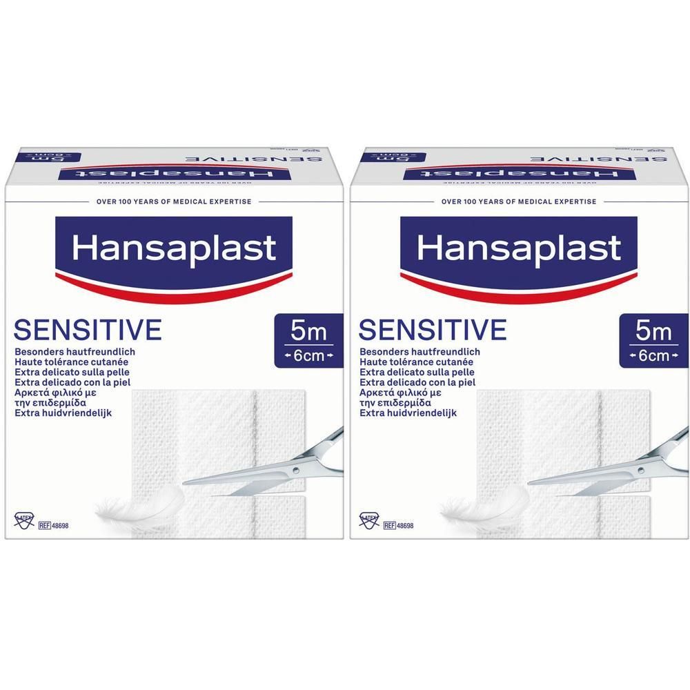 Deux boîtes Hansaplast Sensitive. Inscription: Sensitive, 5m x 6cm. Ciseaux et pansement visibles.