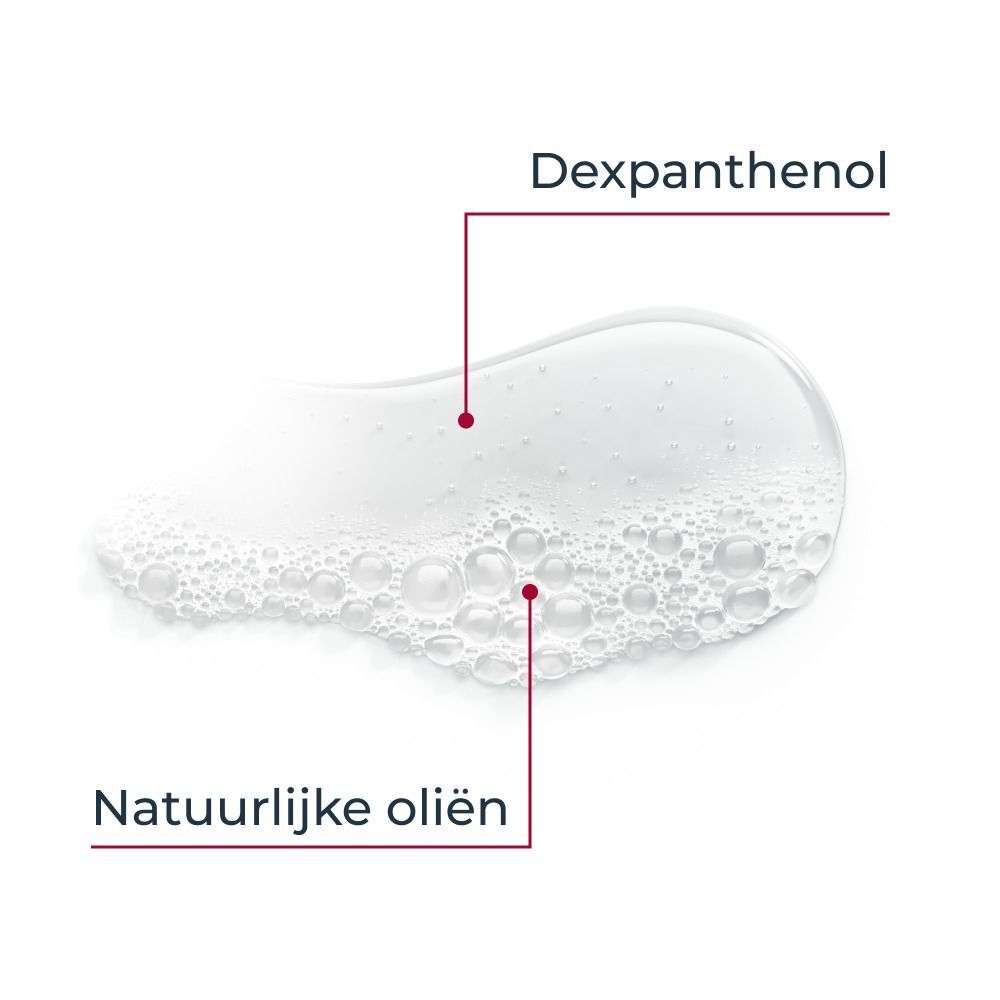 Close-up van Dexpanthenol en natuurlijke oliën. Witte vloeistof met rode markeringen. Nederlandse tekst.