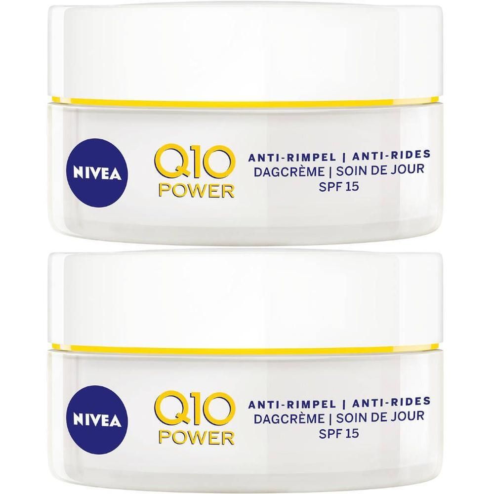 Twee witte potten met gele rand. Opschrift: Nivea, Q10 Power, anti-rimpel dagcrème SPF 15.