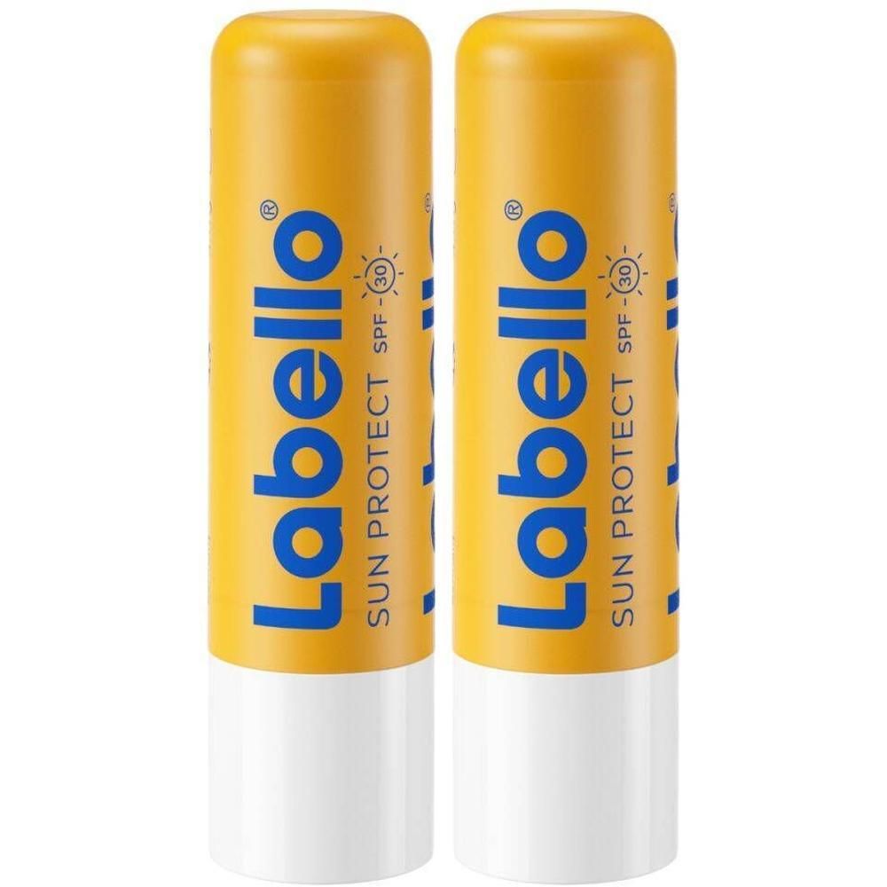 Deux sticks Labello Sun Protect SPF30. Tubes jaunes avec texte bleu. Extrémité blanche du stick.