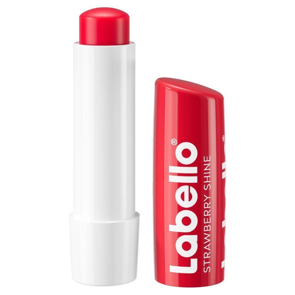 Un stick Labello® Strawberry Shine rouge, ouvert. Bâton blanc, capuchon rouge avec texte blanc.