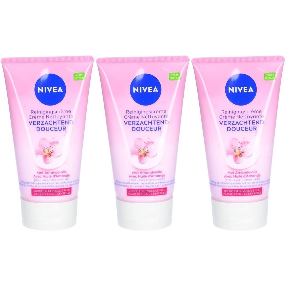 Drie tubes NIVEA reinigingscrème. Roze tubes met blauw logo en productnaam. Illustratie van een bloem.