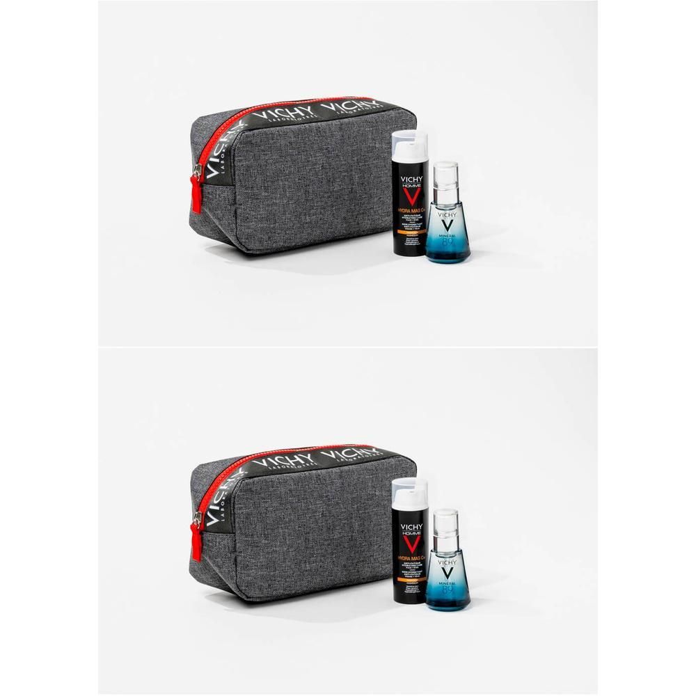 Trousse de toilette grise avec fermeture éclair rouge, deux flacons et un flacon spray. Logo Vichy visible.