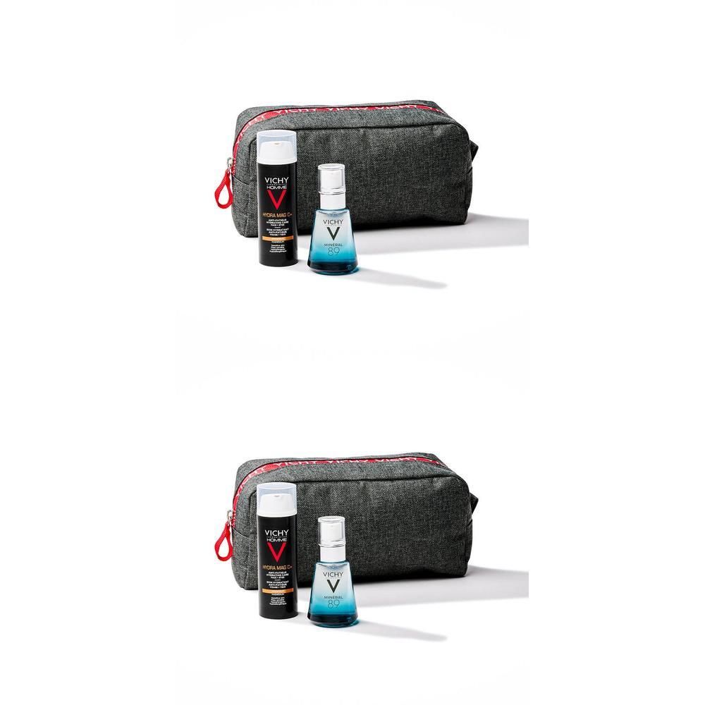 Grijze toilettas met twee producten: fles met witte dop en spuitfles. Vichy-logo zichtbaar.