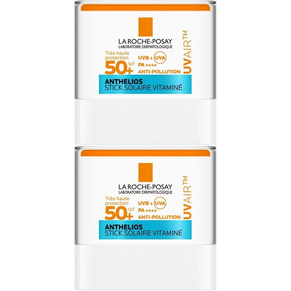 Twee La Roche-Posay Anthelios UVair sticks. Witte houder, oranje deksel, blauwe tekst.