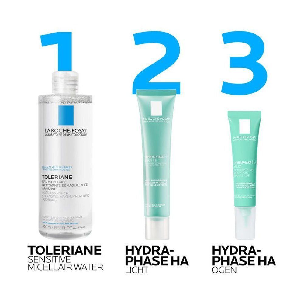 Een lichtgroene tube La Roche-Posay Hydraphase HA Crème de Jour Légère, vastgehouden door een hand.