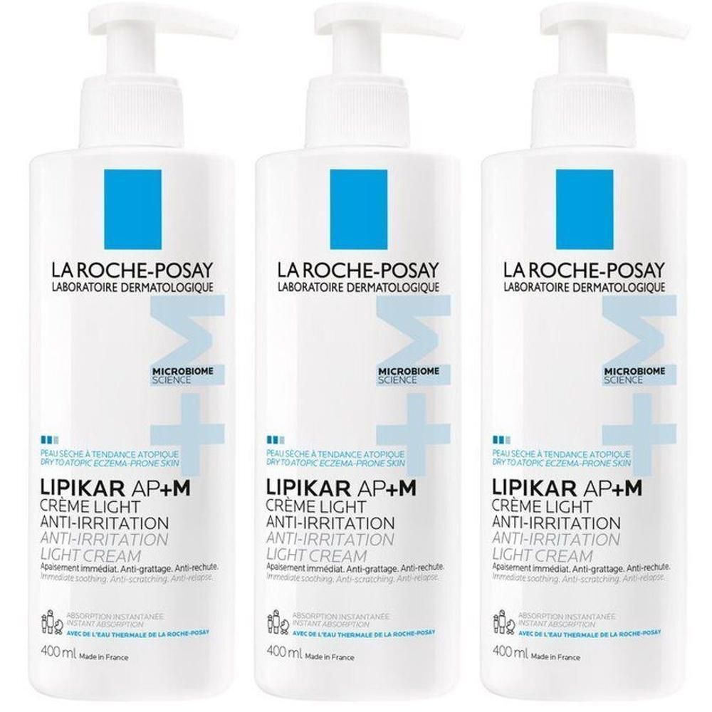 Trois flacons de La Roche-Posay Lipikar AP+M Crème Light. Flacons blancs avec logo bleu et nom du produit.