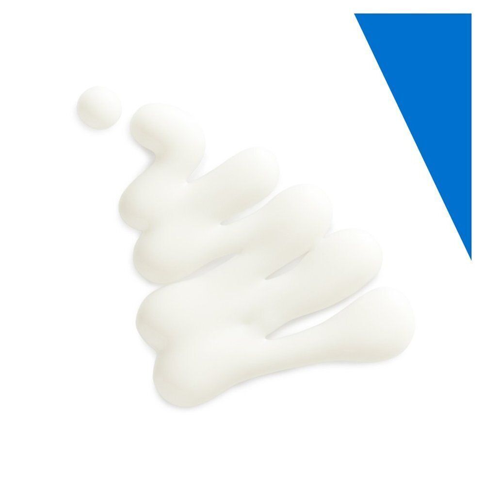 Texture de crème blanche sur fond blanc. Un angle bleu est dans le coin supérieur droit.