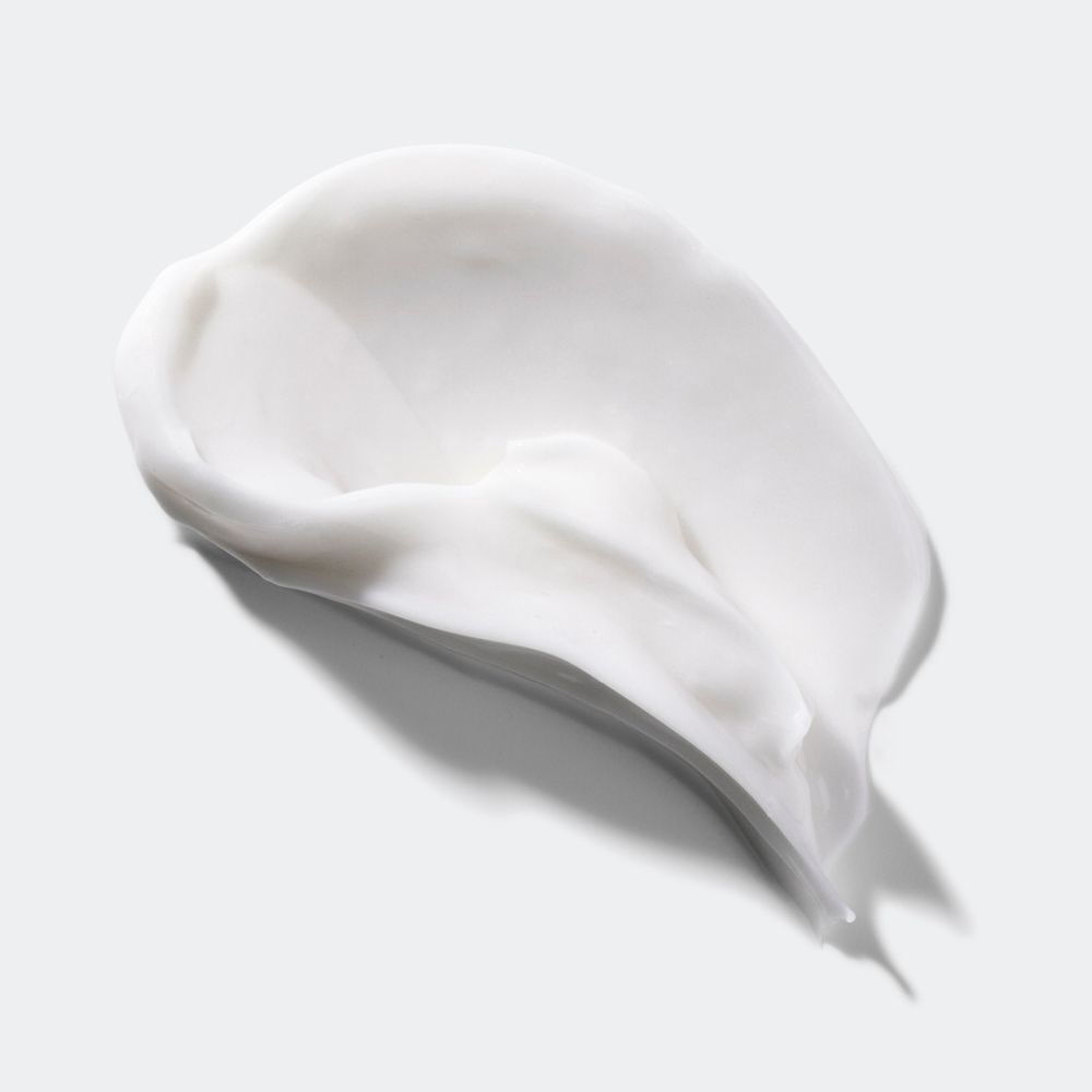Een witte crème textuur verspreid op een glad oppervlak.