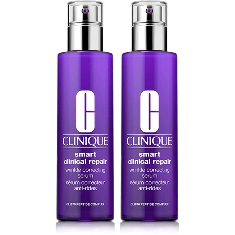 Twee flessen Clinique Smart Clinical Serum. Paarse flessen met zilveren pompen. Tekst: Clinique, Smart Clinical Repair, anti-rimpel serum.