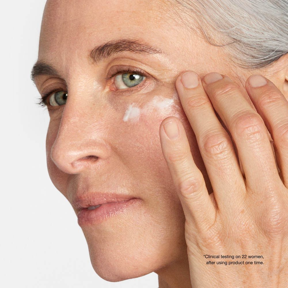Femme appliquant de la crème sur le contour des yeux. Texte : Tests cliniques sur 22 femmes après une seule utilisation.