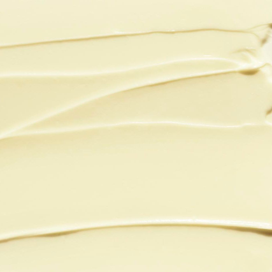Close-up van de romige textuur van CLINIQUE Deep Comfort hand- en nagelcrème. Gladde, golvende applicatie.