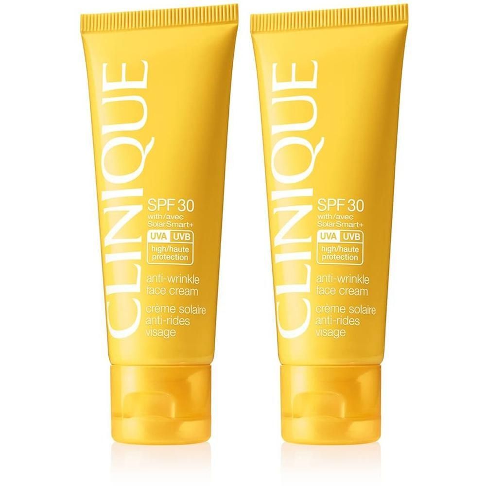 Deux tubes jaunes de crème solaire Clinique SPF 30. Inscription : Anti-Wrinkle Face Cream, Crème Solaire Anti-Rides Visage. Protection UVA/UVB.