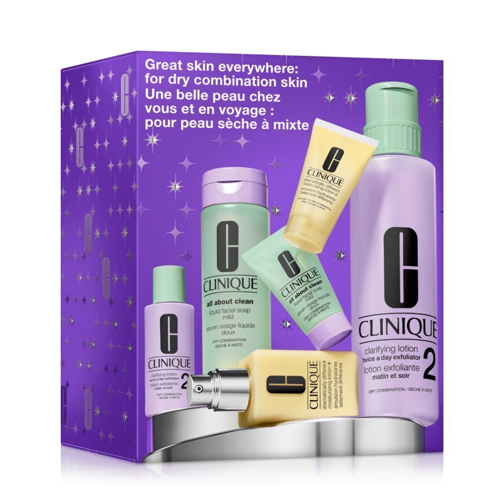 Coffret cadeau Clinique avec divers produits de soin. Emballage violet avec motif d'étoiles. Contient des flacons, des tubes et des noms de produits.