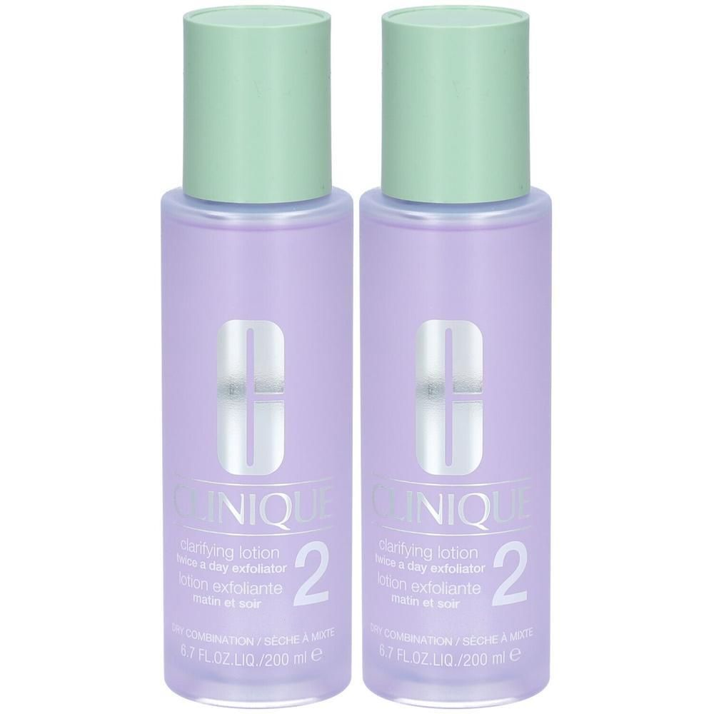 Deux flacons de Clinique Lotion clarifiante Step-2. Flacons violets avec bouchons verts. Inscription: Clinique, 2, Lotion.