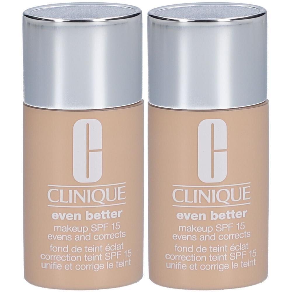 Twee flacons Clinique Even Better foundation. Beige cilindrische containers met zilveren doppen. Tekst: Even Better, SPF 15.